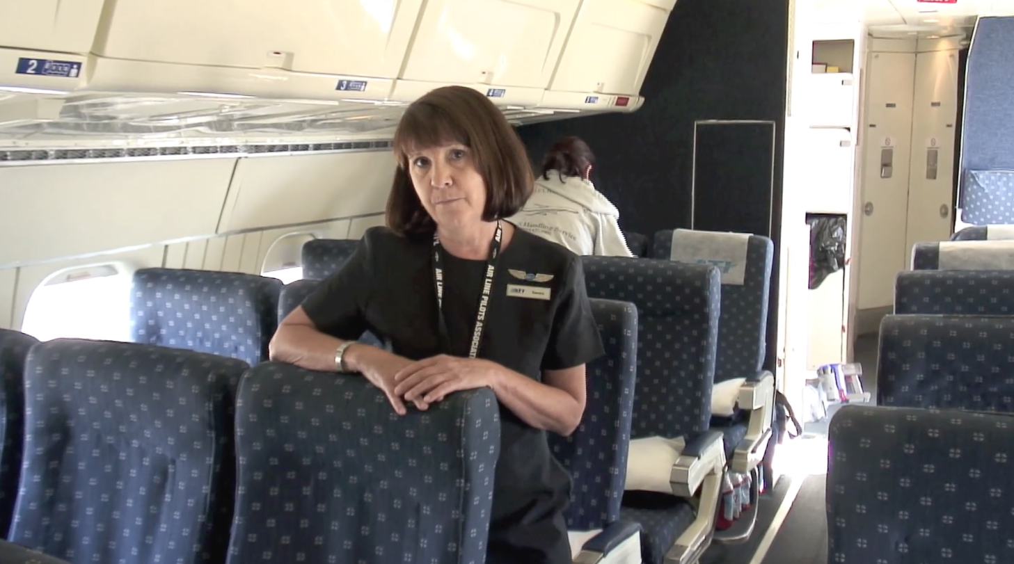 ATI flight attendant Sandra Lucas-Detricks talks with Tenby onboard the ATI DC-8-62 N799AL at Travis AFB on May 12, 2013. This is a screenshot from the 9 episode mini series "DC-8 Farewell" that streams on the JetFlix TV streaming service for aviation super fans.