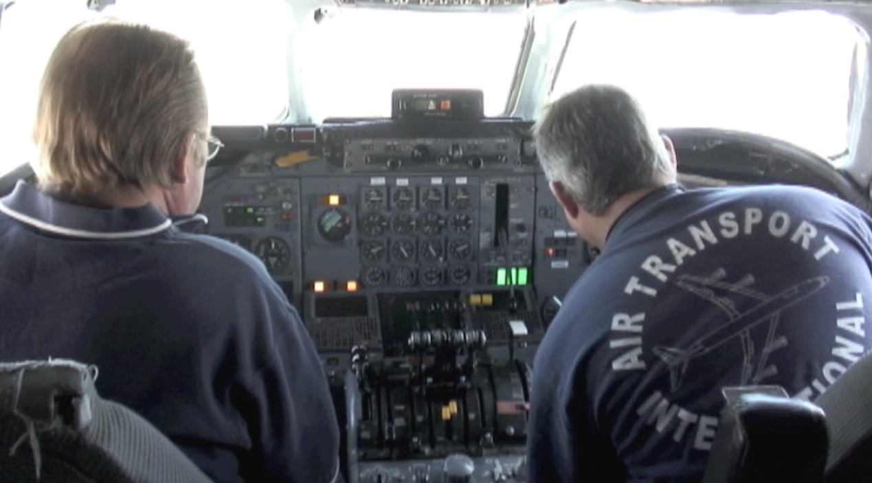 ATI maintenance engineers Robert Dobler and Phil Sisco seated in the cockpit of board ATI DC-8-62 N799AL at McClellan Airport on May 10, 2013, in preparation for a taxi and max power engine check on two of the JT3 engines. JetFlix TV's Henry Tenby filmed the entire event using multiple video camera on the flight deck, exterior of the aircraft and in the cabin viewing the wings and engines. The check was performed by ATI maintenance and engineers Robert Dobler and Phil Sisco. Two days later this aircraft was filmed on its flight to Travis AFB. This is a screenshot from the 9 episode mini series "DC-8 Farewell" that streams on the JetFlix TV streaming service for aviation super fans.