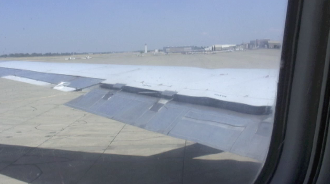 View of the wings from the passenger cabin of ATI DC-8-62 N799AL at McClellan Airport on May 10, 2013, during live taxi and max power engine check on two of the JT3 engines. JetFlix TV's Henry Tenby filmed the entire event using multiple video camera on the flight deck, exterior of the aircraft and in the cabin viewing the wings and engines. The check was performed by ATI maintenance and engineers Robert Dobler and Phil Sisco. Two days later this aircraft was filmed on its flight to Travis AFB. This is a screenshot from the 9 episode mini series "DC-8 Farewell" that streams on the JetFlix TV streaming service for aviation super fans.