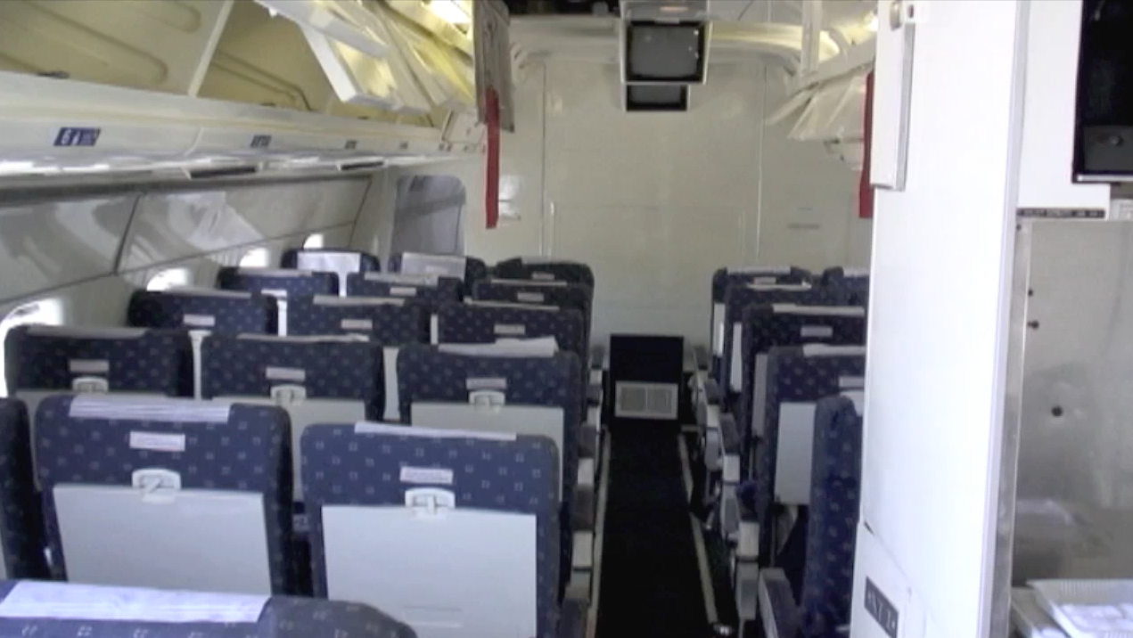 Passenger cabin view looking forward during a maintenance inspection of ATI DC-8-62 N799AL at McClellan Airport on May 10, 2013. This is a screenshot from the 9 episode mini series "DC-8 Farewell" that streams on the JetFlix TV streaming service for aviation super fans.