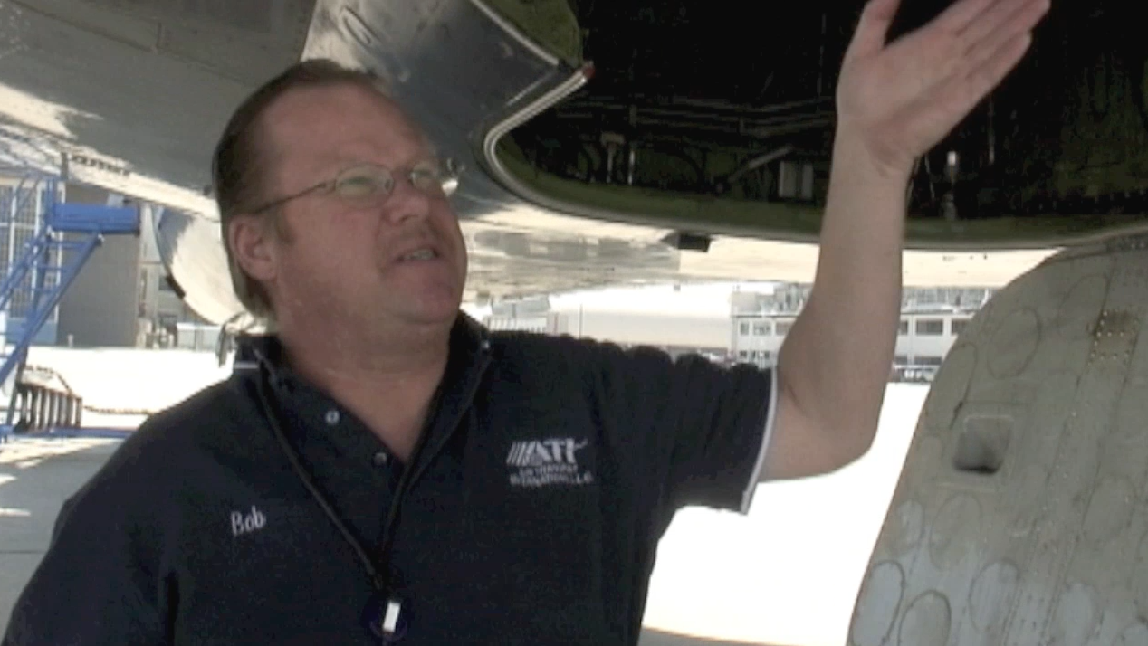 ATI maintenance engineer Robert Dobler presenting the landing gear bay during a aircraft systems tour of ATI DC-8-62 N799AL at McClellan Airport on May 10, 2013. This is a screenshot from the 9 episode mini series "DC-8 Farewell" that streams on the JetFlix TV streaming service for aviation super fans.
